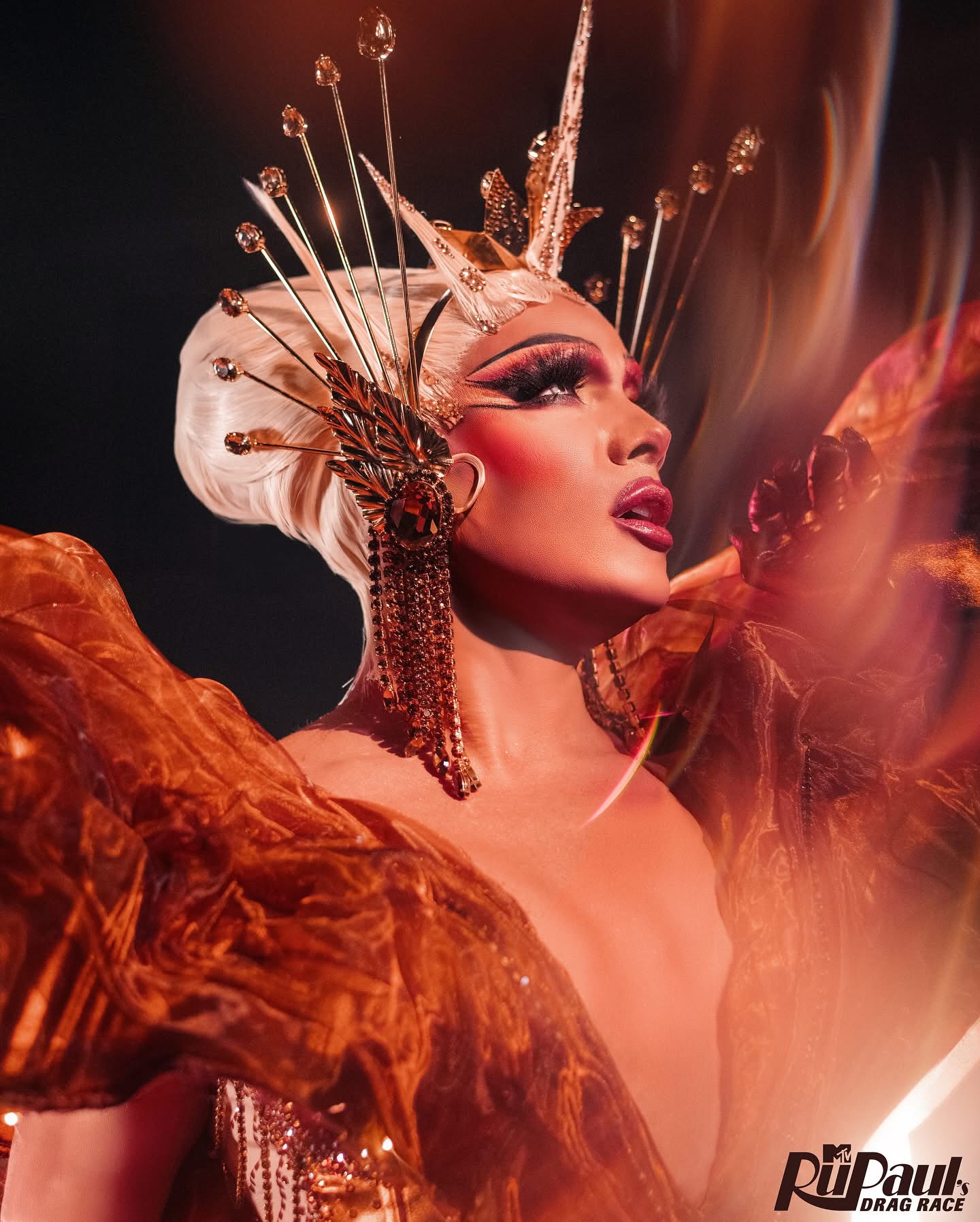 Close-up of Athena Dion wearing a sculptural gold crown